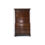 A George III oak chest on chest, with a dentil cornice, over two short and six graduated long