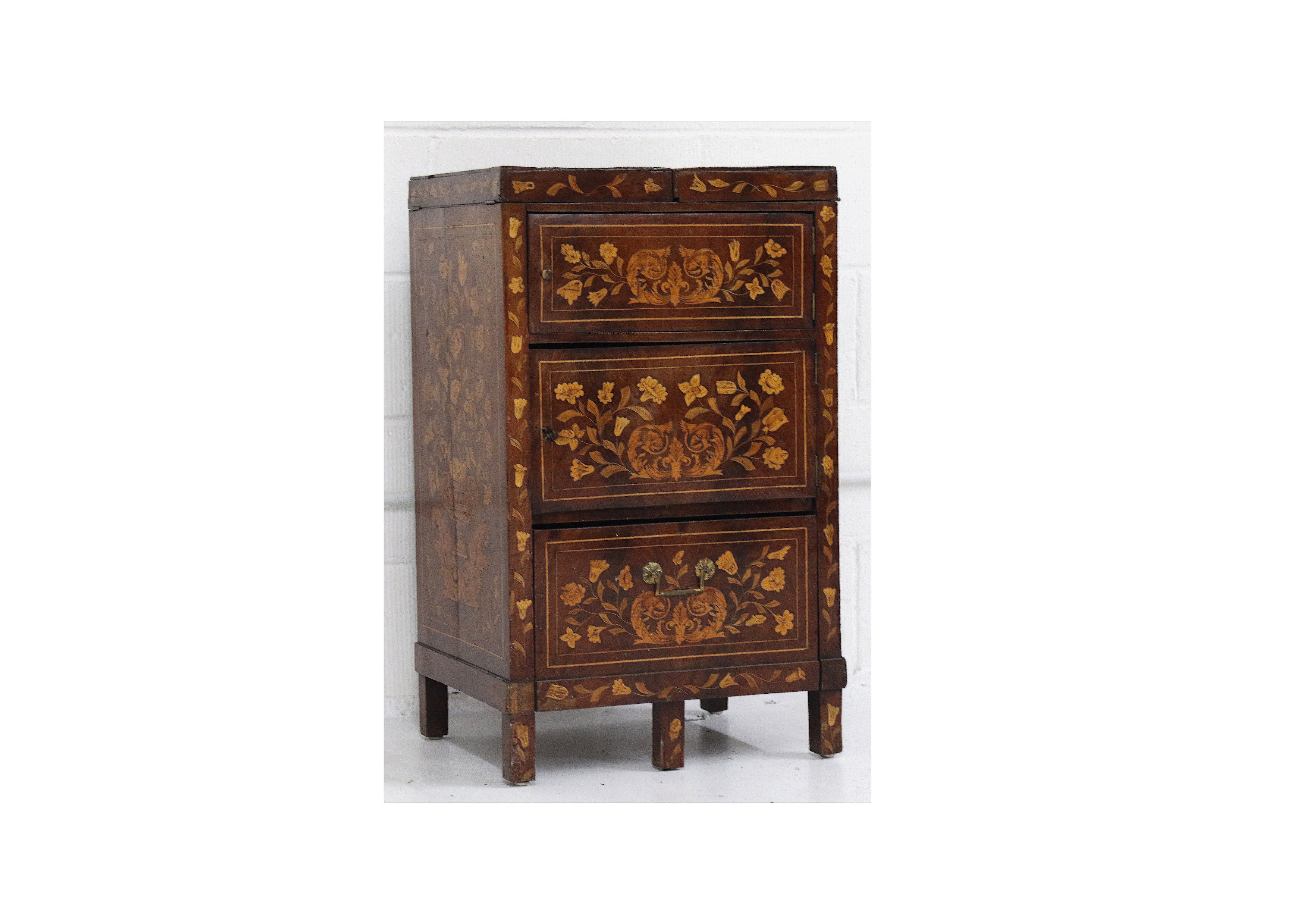 An early 19th Century Dutch walnut and floral marquetry inlaid enclosed washstand, the twin flap top