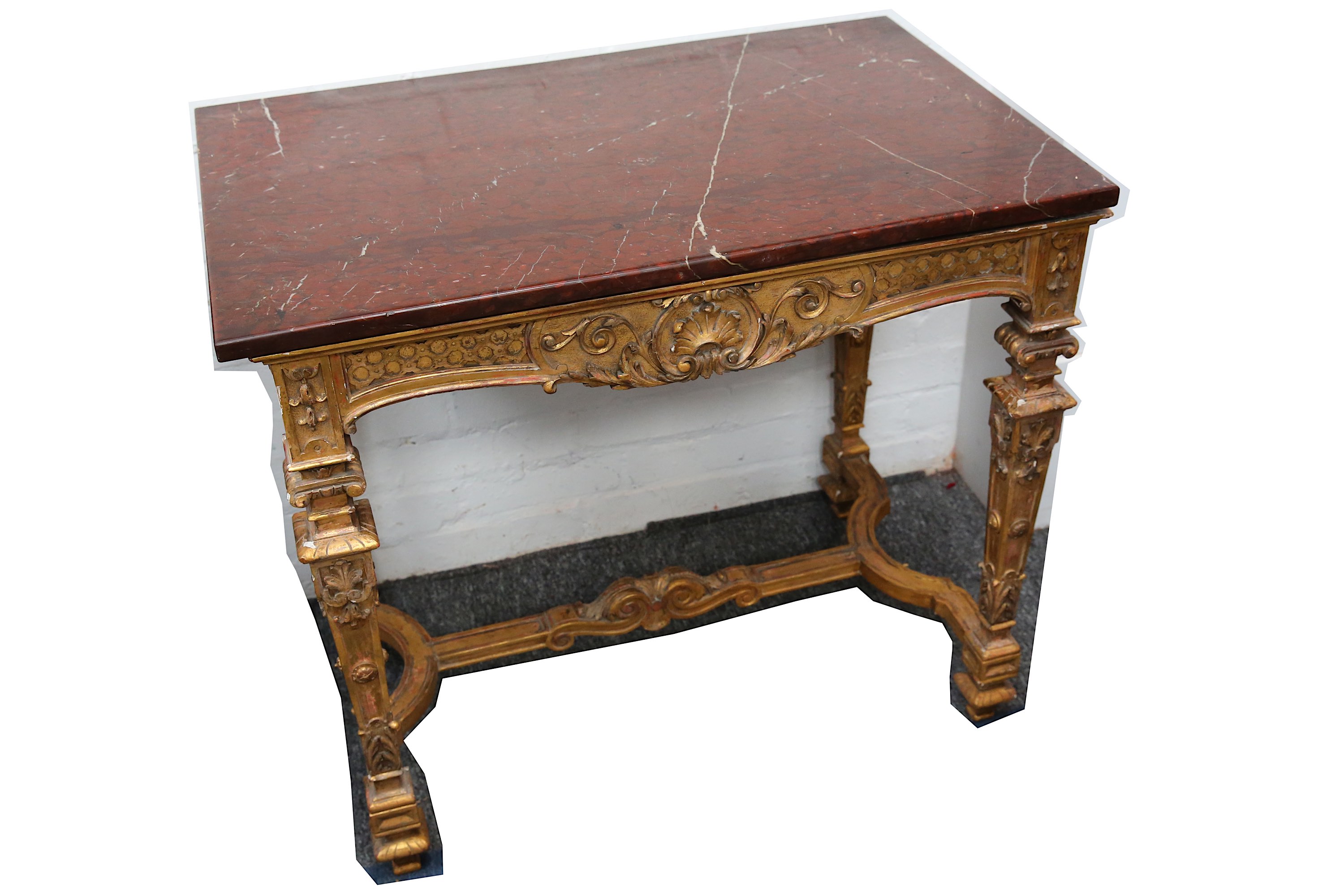 A 19th Century Italian style carved giltwood and gesso centre table, with a variegated red marble