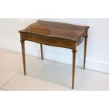 A late 19th to early 20th Century rosewood table with ivory line inlay, of serpentine outline