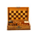 An Edwardian burr walnut veneered games compendium, the rectangular brass bound case opening to