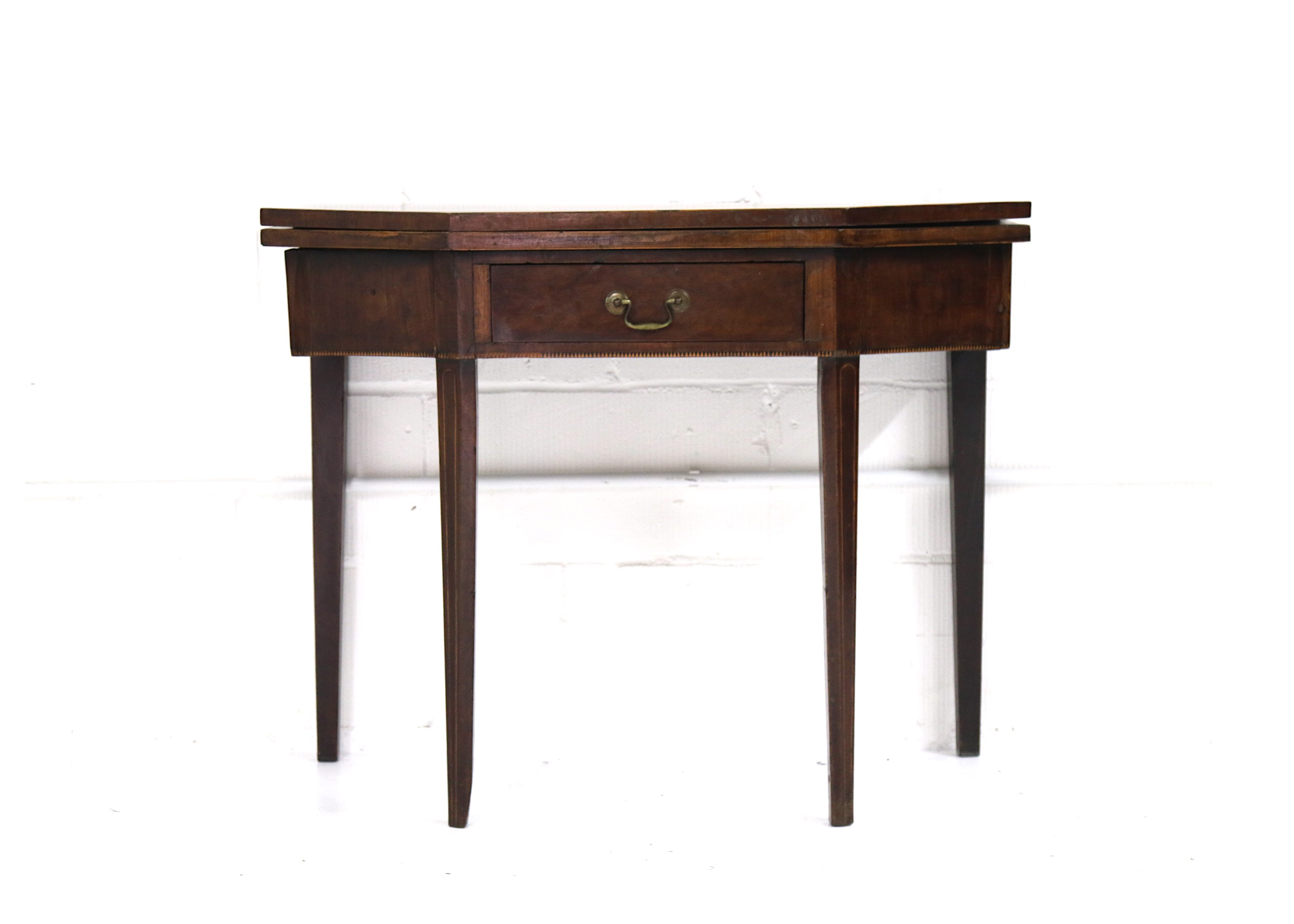 An early 19th Century provincial walnut folding card table, fitted with a drawer, on square