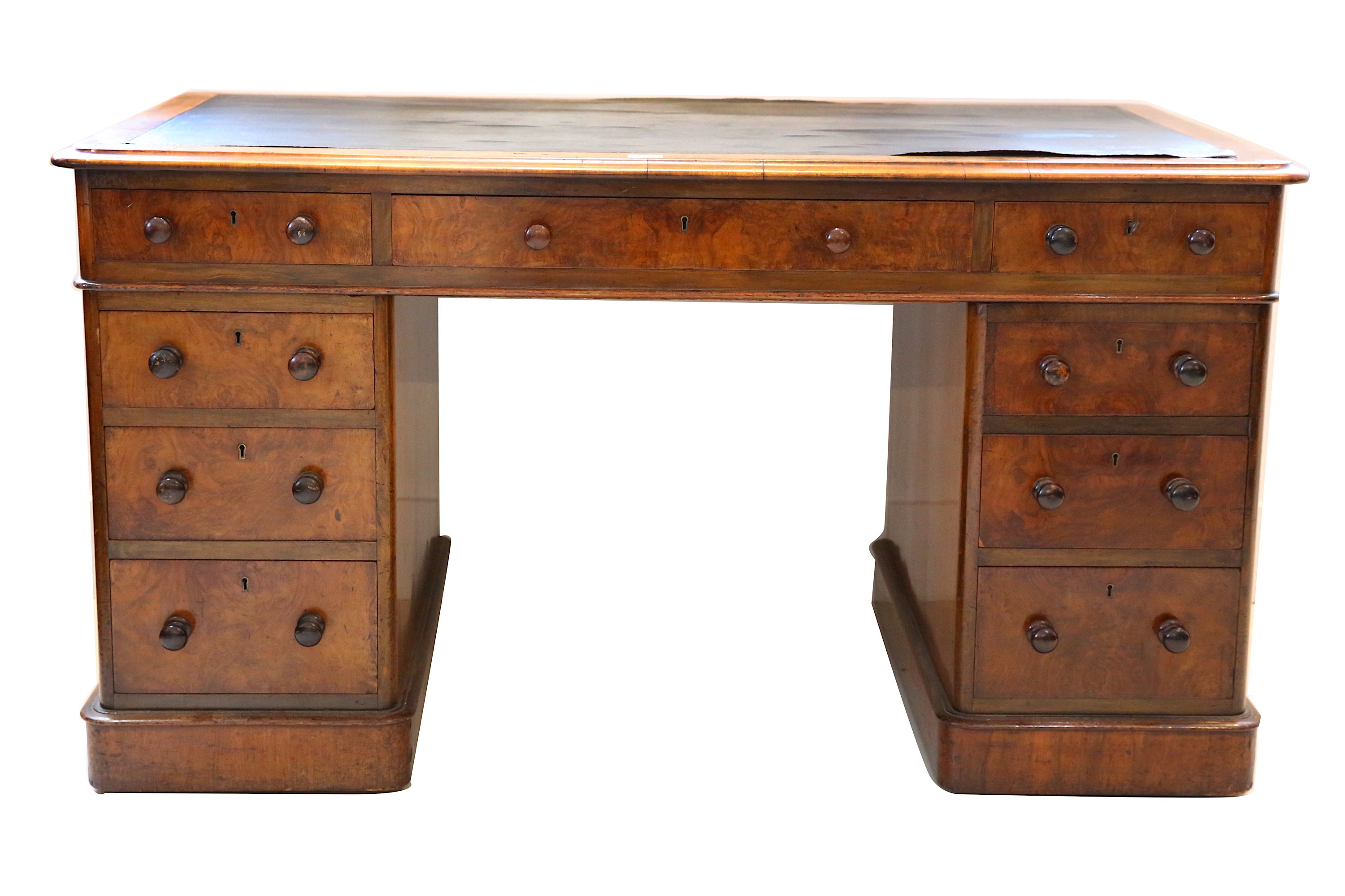 A Victorian figured walnut pedestal desk, with rounded rectangular top over nine drawers, on a