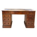 A Victorian figured walnut pedestal desk, with rounded rectangular top over nine drawers, on a