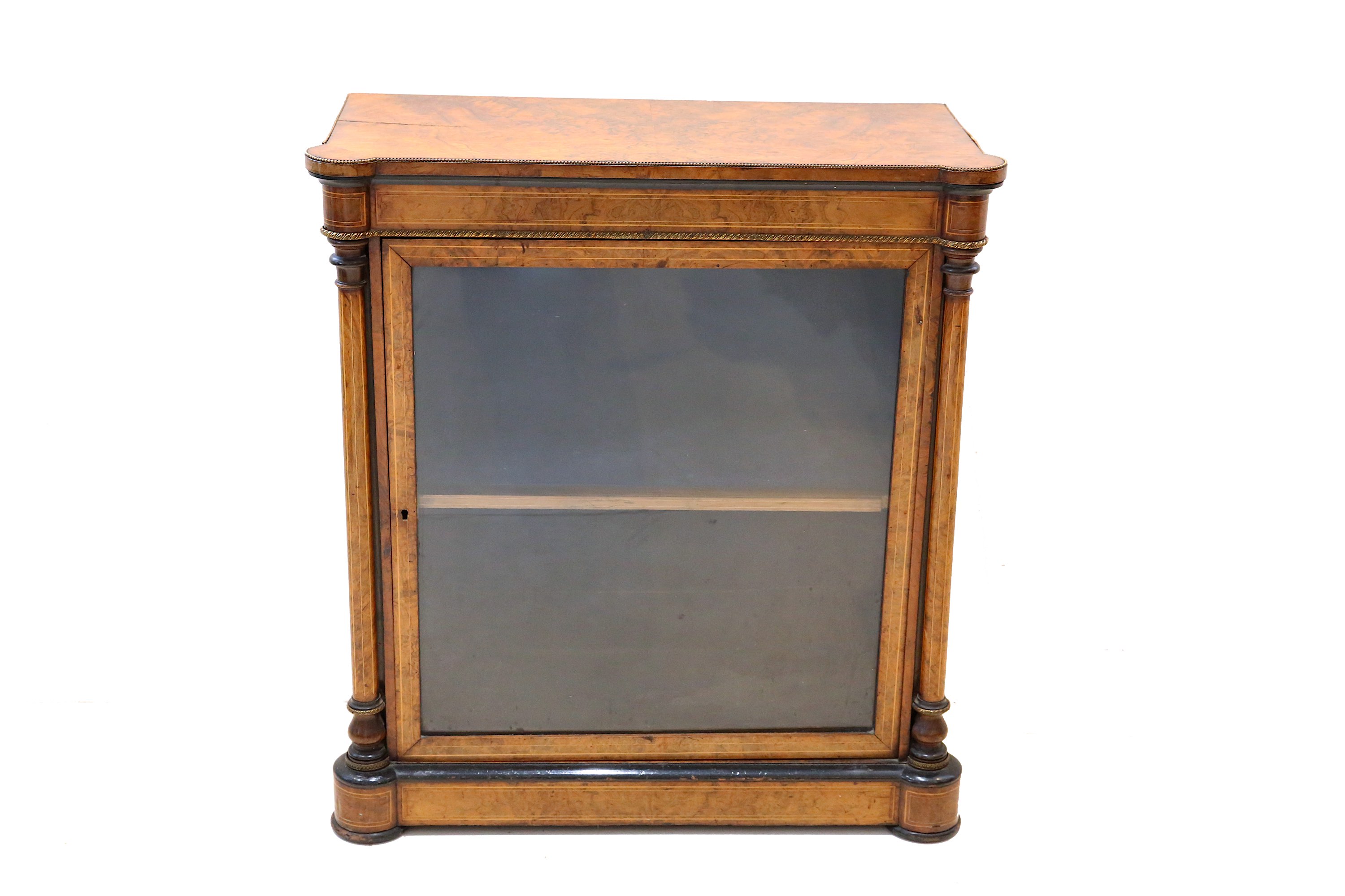 A small Victorian boxwood strung figured walnut pier cabinet, the glazed door flanked by turned