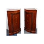 A pair of Edwardian satinwood banded marquetry inlaid mahogany bowfront corner cabinets, in the
