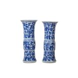 A PAIR OF CHINESE BLUE AND WHITE MOULDED 'LANDSCAPE' BEAKER VASES, GU. Kangxi. Of cylindrical form