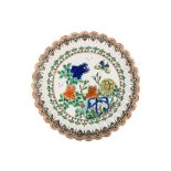 A CHINESE FAMILLE VERTE ‘FLOWER AND BUTTERFLY’ MOULDED DISH. Kangxi. Brightly enamelled in green,