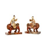 A PAIR OF SOAPSTONE FIGURES OF LADIES ON LIONS. Early Qing Dynasty. Seated side-saddle in mirror