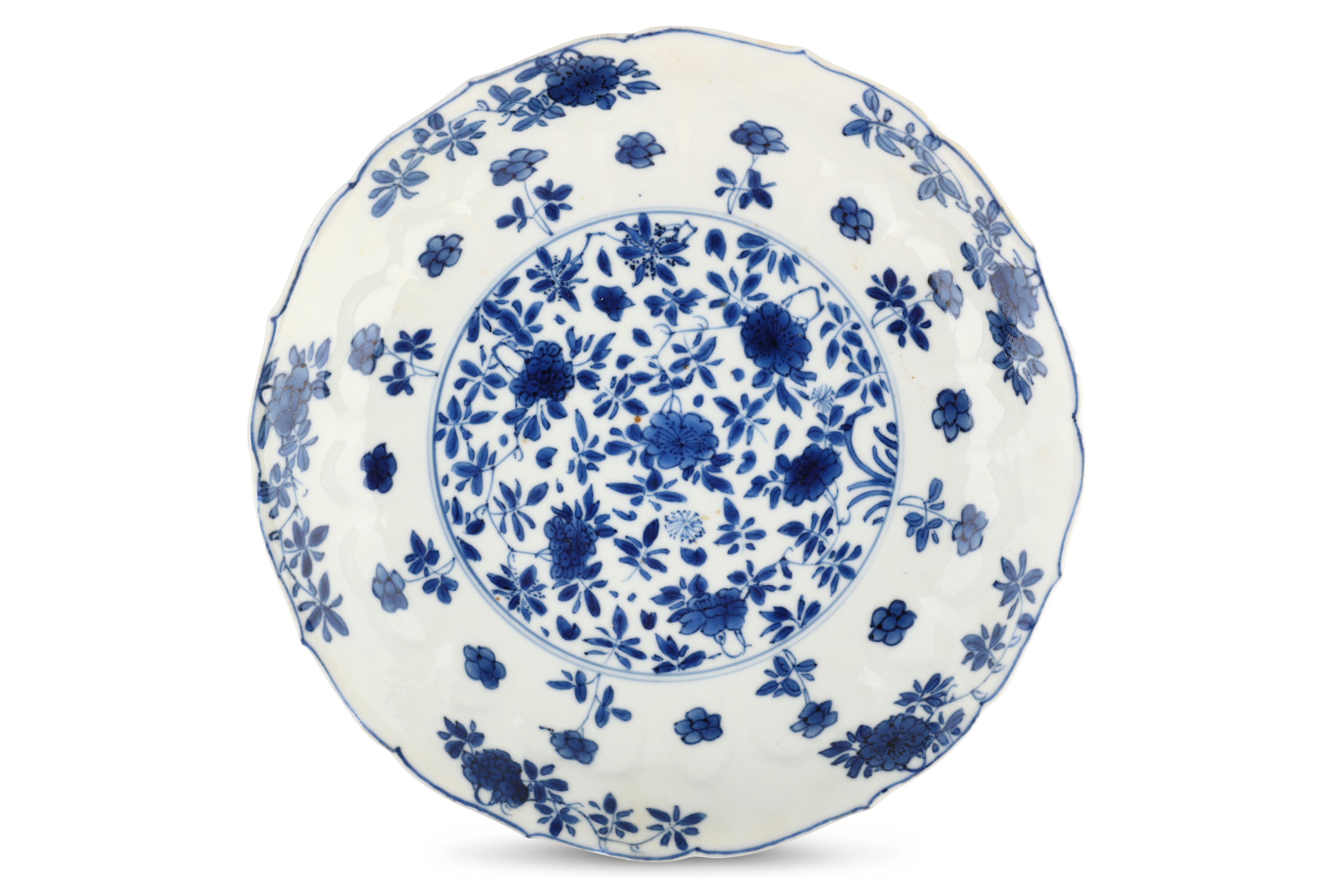 A CHINESE BLUE AND WHITE 'FLOWERS' MOULDED DISH. Kangxi mark and of the period. Decorated with a