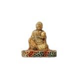 A CHINESE SOAPSTONE FIGURE OF A LOHAN HOLDING A PEACH. Early Qing, signed Zifu. Carved seated on