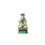 A CHINESE BISCUIT FAMILLE VERTE FIGURE OF A SEATED BUDDHA Kangxi. The crowned figure seated in a