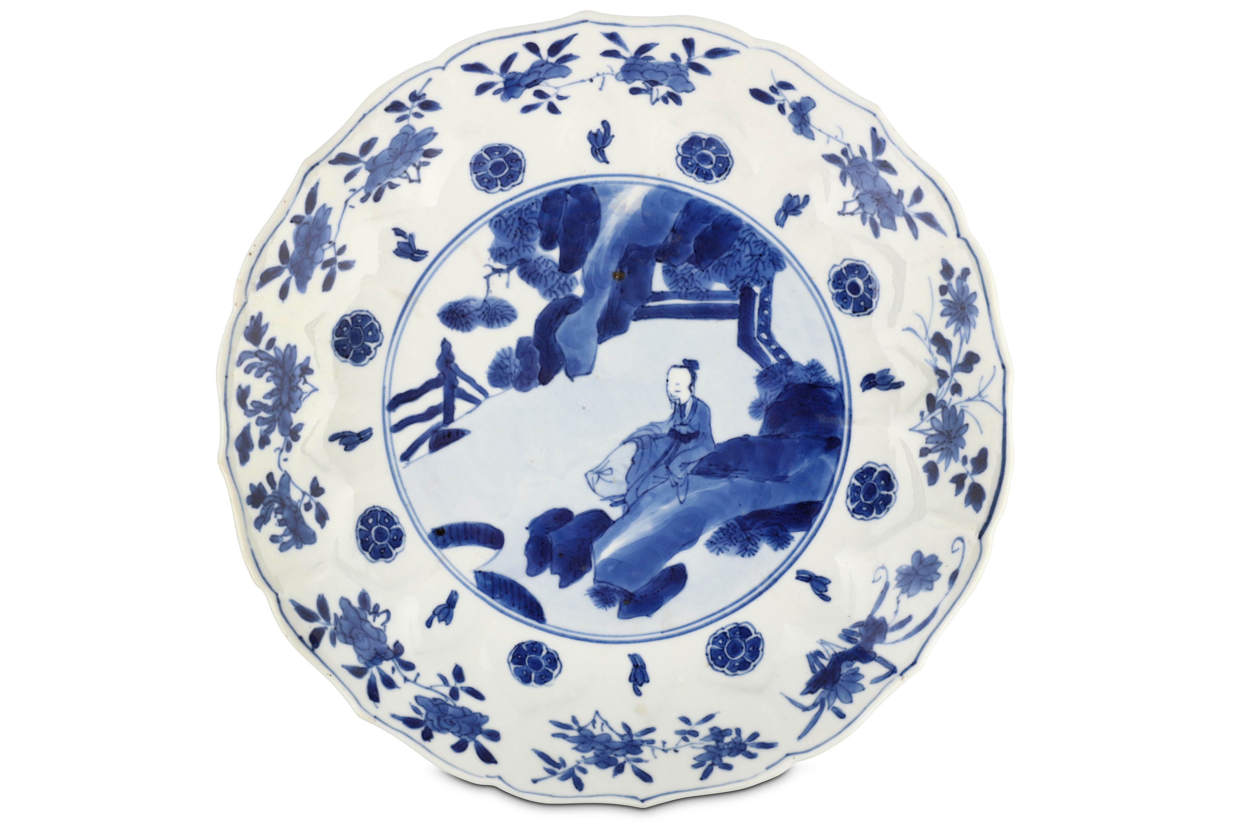 A CHINESE BLUE AND WHITE 'SCHOLAR' DISH. Kangxi mark and of the period. The central roundel painted