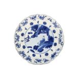 A CHINESE BLUE AND WHITE 'SCHOLAR' DISH. Kangxi mark and of the period. The central roundel painted