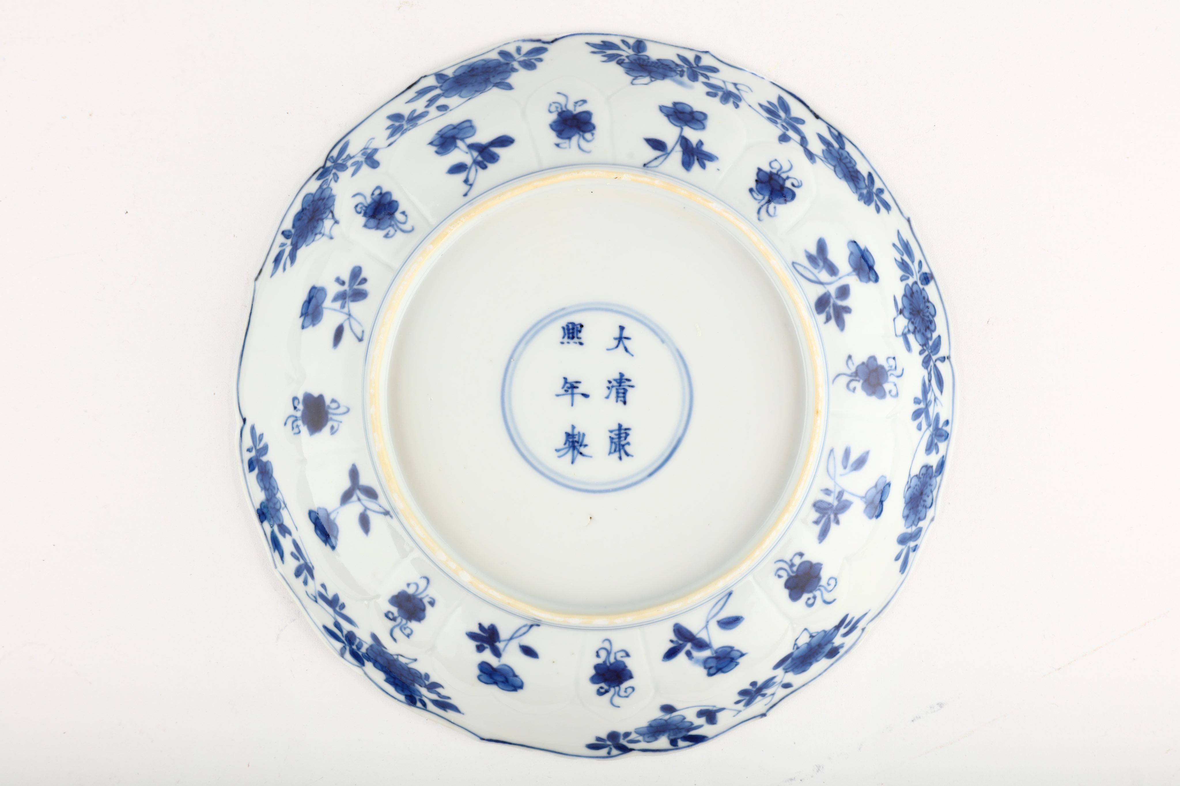 A CHINESE BLUE AND WHITE 'FLOWERS' MOULDED DISH. Kangxi mark and of the period. Decorated with a - Image 2 of 3