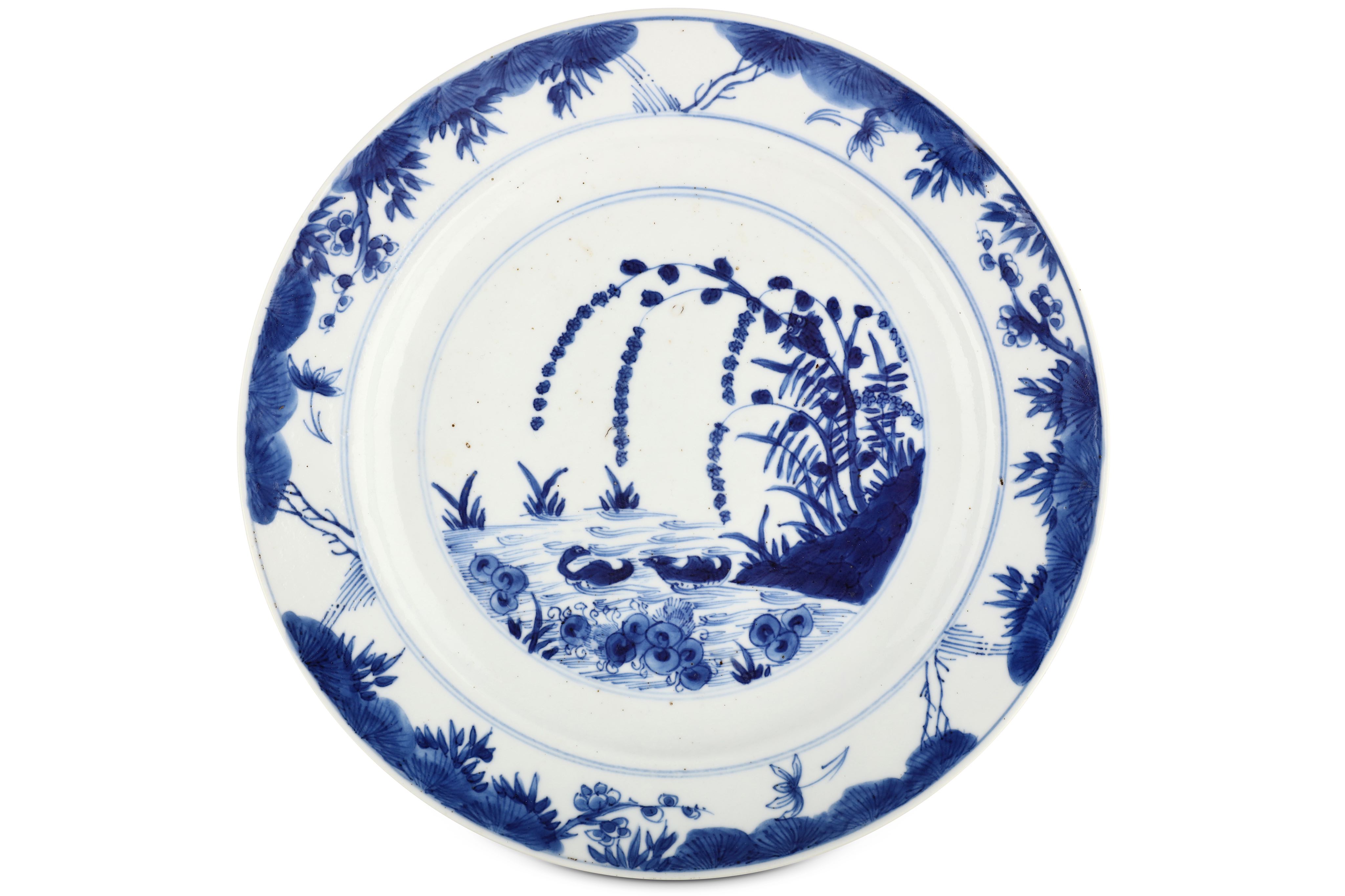 A CHINESE BLUE AND WHITE ‘MANDARIN DUCKS’ DISH. Kangxi mark and of the period. Painted with a