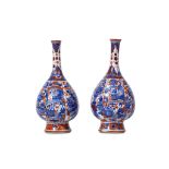 A PAIR OF CHINESE IMARI-DECORATED VASES. Kangxi. Each of pear-shape form with a spreading foot and a