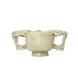 A CHINESE CARVED JADE ‘LOTUS’ HANDLED BOWL. Qing D