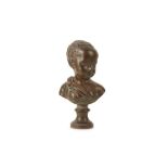 AN 18TH CENTURY FRENCH PATINATED TERRACOTTA BUST OF A YOUNG BOY IN THE MANNER OF JEAN-ANTOINE HOUDON