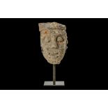 A 13TH CENTURY GOTHIC CARVED LIMESTONE HEAD an architectural fragment, now raised on a metal