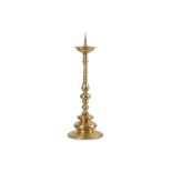 A LARGE LATE 17TH CENTURY GERMAN BRONZE PRICKET CANDLESTICK the dished top raised on the baluster,