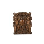 A 17TH CENTURY NORTH EUROPEAN CARVED WALNUT PANEL WITH A CARTOUCHE the relief carved panel with a