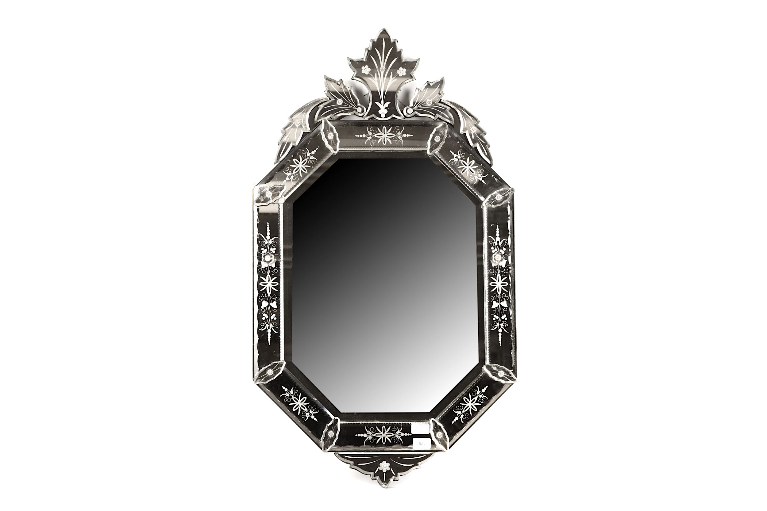 An early 20th Century Venetian style bevelled glass wall mirror with shaped crest above