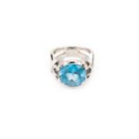 A synthetic blue spinel ring, The circular-cut synthetic blue spinel, between openwork shoulders, to