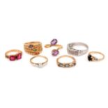 A group of rings, Including a diamond single-stone ring, a diamond dress ring, an amethyst bypass