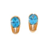 A pair of blue topaz and diamond earrings, Each oval fancy-cut blue topaz, to an openwork gallery