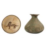 A BRONZE JUG AND A POTTERY BOWL WITH A CHEETAH Iran, possibly 12th century and later, the jug with a