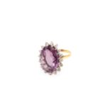 An amethyst and diamond ring, Set with an oval-cut amethyst, within a brilliant-cut diamond