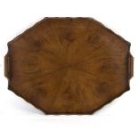 A walnut octagonal two-handled tray, the base of eight fan shaped oyster veneers,