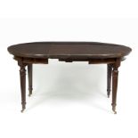 A mahogany extending dining table with two extra leaves,