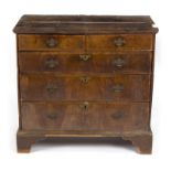 An early 18th Century crossbanded chest of two short over three long drawers, on bracket feet, 95.