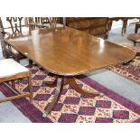 A George III mahogany breakfast table, the rectangular top with round corners and tilt action,