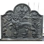 A cast iron fire back of arched form, decorated a lion, 69cm high x 77.