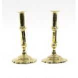 A pair of 18th Century baluster brass candlesticks on petal bases,