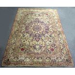 An Isfahan rug, the central field with floral motifs within a multifield border in reds and pinks,