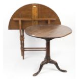 A late Victorian coaching table, the folding circular top on turned legs, 95.