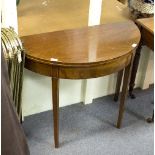 A mahogany half-round table with fold over top on square tapering legs,