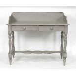 A painted washstand, the three-quarter galleried top above two drawers on turned legs,