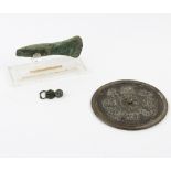 A bronze axe head, a Chinese metal mirror,