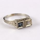 A diamond and sapphire two-stone ring in a pierced and engraved 18ct white gold mount,