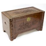 A Chinese chest with carved hinged cover and front panel,