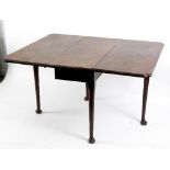 A George II mahogany drop leaf table, the rectangular top with indented corners,