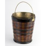 A turned wood bucket, with bands of ebonised decoration and brass swing handle,