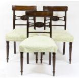 Three late George III mahogany chairs with stuff over seats, on turned legs,