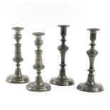 Two pairs of early 19th Century pewter candlesticks, each with baluster stem on circular foot,