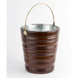 A turned wood bucket, with brass swing handle,